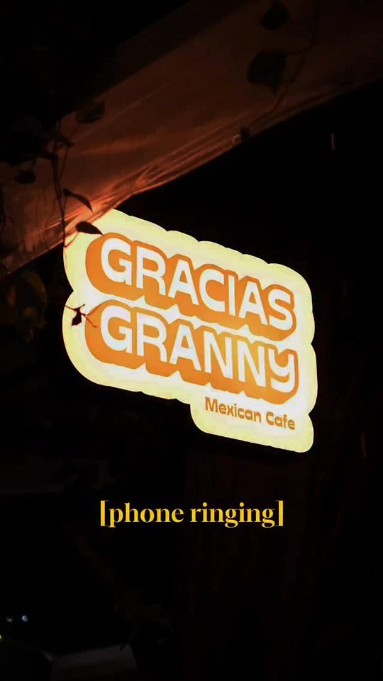 The lit-up Gracias Granny Mexican Cafe sign at night